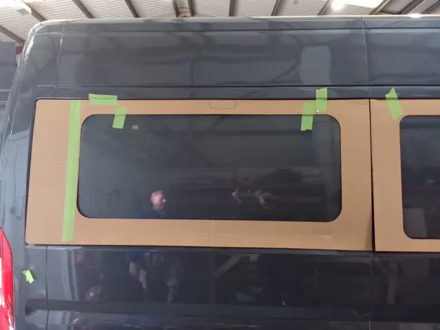 New window glass taped in place while the bond cures